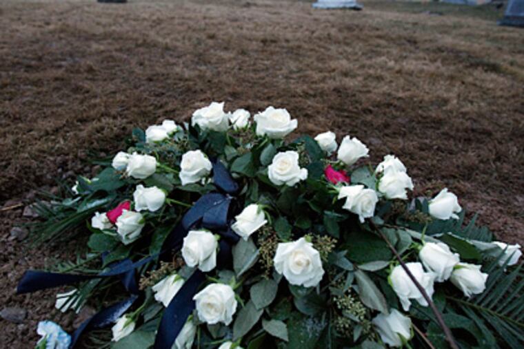 Flowers that adorned Joe Paterno's casket lie on what is likely his burial site at Spring Creek Presbyterian Cemetery near the Centre Hills Country Club. (David Maialetti / Staff Photographer)
