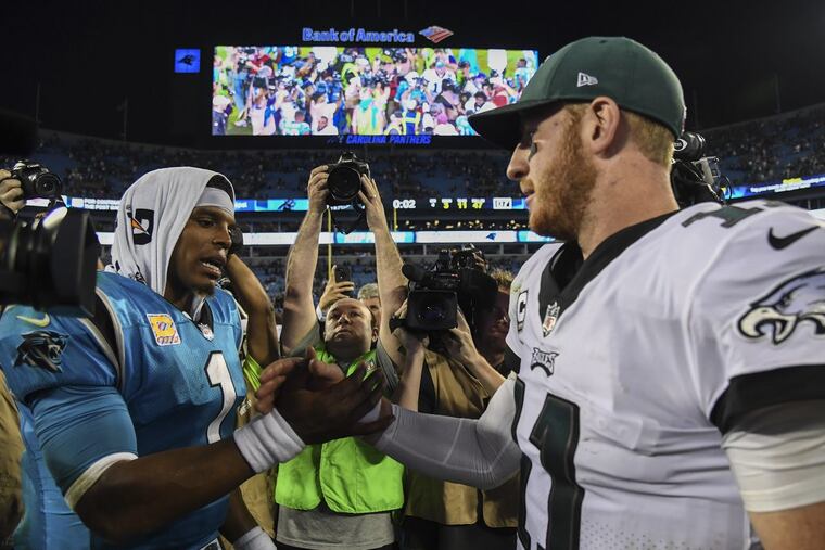Eagles quarterback Carson Wentz greets Panthers quarterback Cam Newton after the Eagles beat the Panthers 28-23 at Bank of America Stadium October 12, 2017.