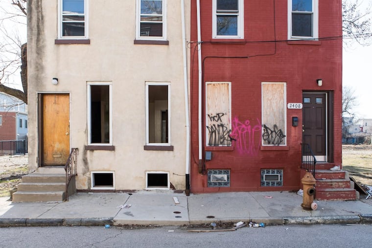 Homes sits vacant with boarded up windows on the 2400 block of Redner Street in North Philadelphia on Wednesday morning, February 14, 2018.