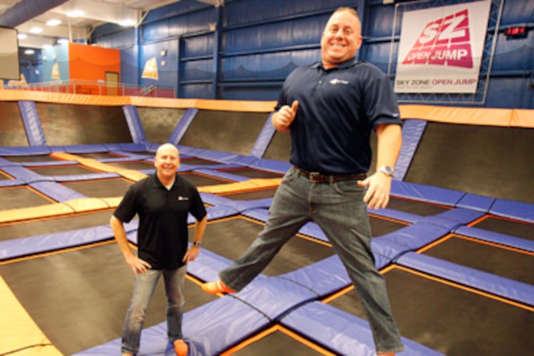 Sky Zone President Rich Ferns, (right) and Vice President Phil Stoops are showing off on the trampolines inside the Sky Zone Indoor Trampoline Park in Glen Mills. (AKIRA SUWA/Staff Photographer)