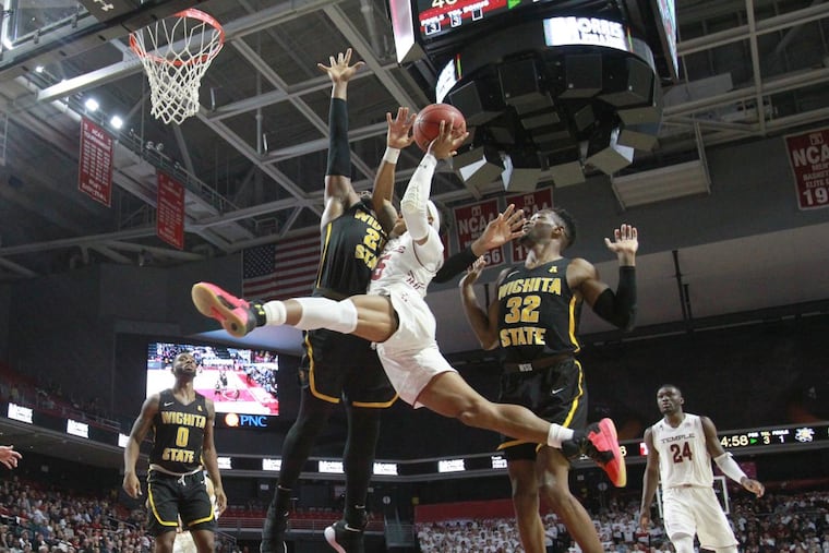 Nate Pierre-Louis of Temple going up for a shot between Shaquille Morris, left, and Markis McDuffie of Wichita State last Thursday.