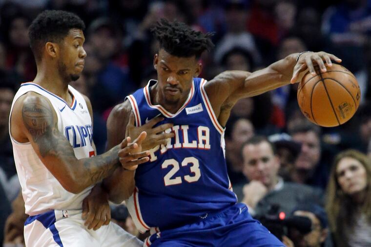 Jimmy Butler protects the ball from Clippers guard Tyrone Wallace on Tuesday.
