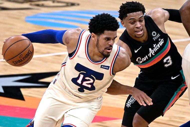 The 76ers' Tobias Harris (12) drives around the San Antonio Spurs' Keldon Johnson during the second half.