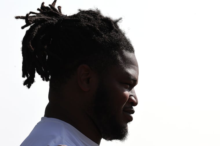 Eagles defensive tackle Jalen Carter pauses on the field before the start of the training camp session on Sunday.