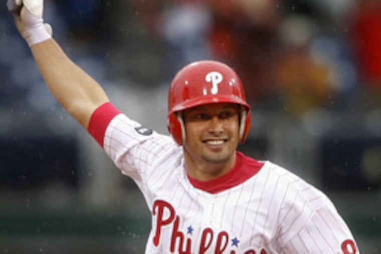 Shane Victorino raises his arm in jubilation as he rounds the bases after smacking a game-winning, walk-off home run in the bottom of the ninth inning to beat the Giants, 9-8, at Citizens Bank Park.