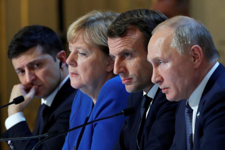 Ukraine's President Volodymyr Zelenskiy, left, German Chancellor Angela Merkel, French President Emmanuel Macron, third left and Russian President Vladimir Putin, right, attend a joint news conference at the Elysee Palace in Paris on Monday.