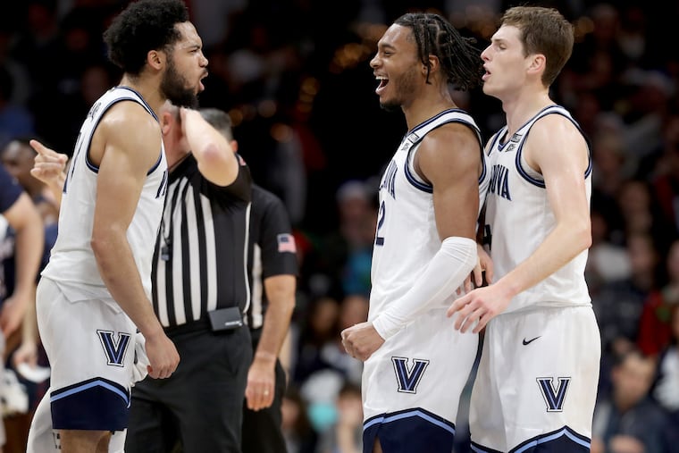 Cam Whitmore (center) of Villanova is congatulated by Cam Daniels (left) and Chris Arcidiacono after Penn was forced to call a timeout during the 2nd half of a Big 5 game on Dec. 7, 2022 at the Finneran Pavilion at Villanova University.