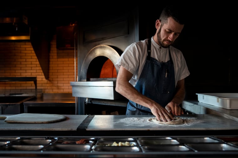 Chef Jim Burke, making a pizza in 2019 at Wm. Mulherin's Sons.