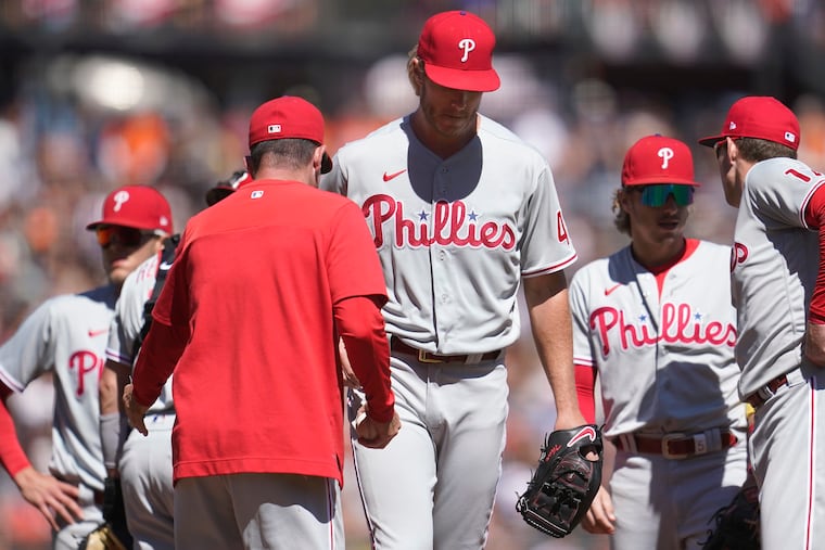 Philadelphia Phillies interim manager Rob Thomson, foreground, takes the ball from pitcher Noah Syndergaard while making a pitching change during the fifth inning of a baseball game against the San Francisco Giants in San Francisco, Saturday, Sept. 3, 2022. (AP Photo/Jeff Chiu)