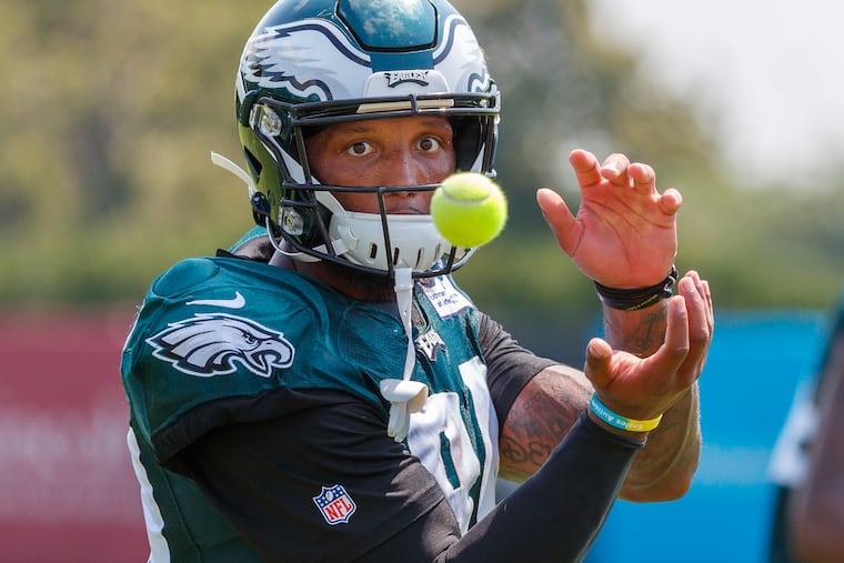 Eagles wide receiver Charles Johnson concentrates on the flying tennis ball as he works on his receiving skills after practice at Eagles training camp.