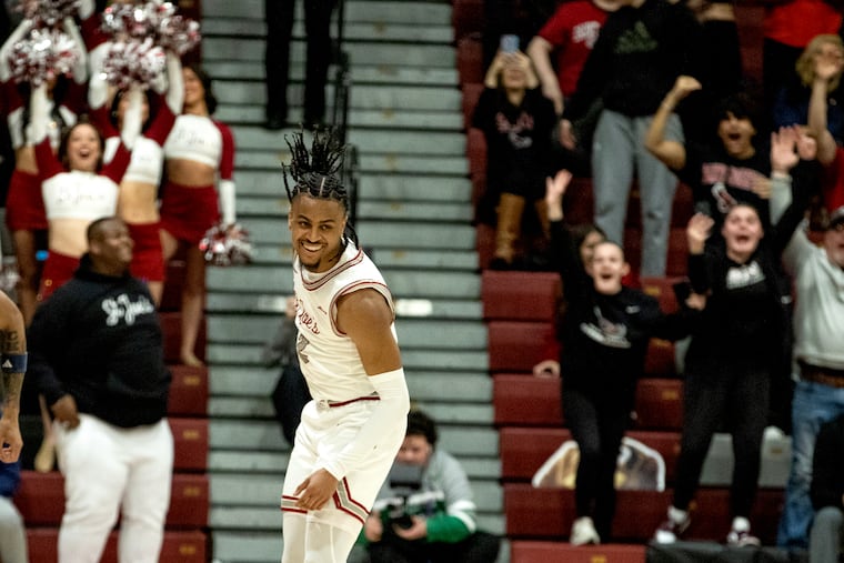 Erik Reynolds II of St. Joseph's is all smiles after hitting a shot to break Jameer Nelson's career scoring record with the Hawks.