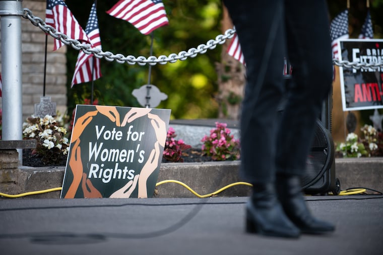 A sign encouraging voters to vote for women’s rights is pictured at the Upper Bucks Rally for our Rights while Pa. Democratic candidate for the U.S. House of Representatives in Pennsylvania’s 1st District, Ashley Ehasz, addresses the crowd at the event on Monday, June 24, 2024 at Lenape Park in Sellersville.