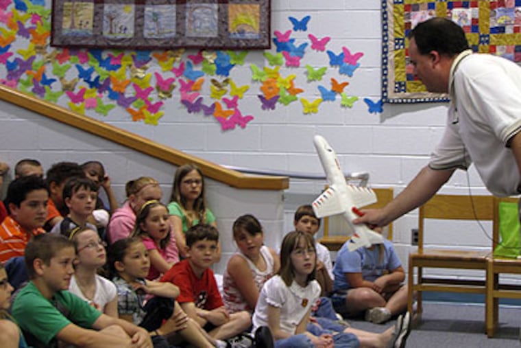 Gary Ross, an engineer with Lockheed Martin, discusses flying and aerodynamics with 4th-graders at Logan Township Elementary School on Friday. (Haley Marks / Inquirer Staff)
