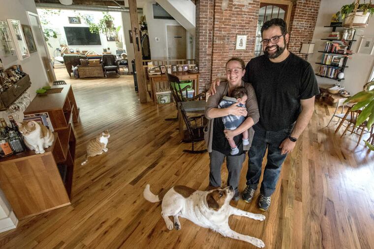Jaime Alvarez and Leah Shepperd, holding their newborn son, Jose Alan Joaquim Alvarez Shepperd, stand in their home on Sepviva Street in Philadelphia May 2, 2017.