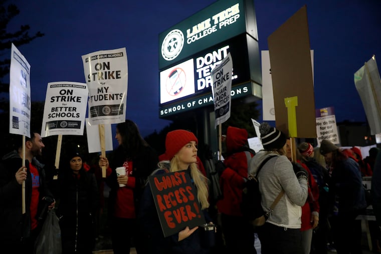 Striking teachers and supporters walk a picket line outside Lane Tech High School in the 2500 block of W. Addison Street in Chicago, on the first day of a strike by the Chicago Teachers Union, Oct. 17, 2019.
