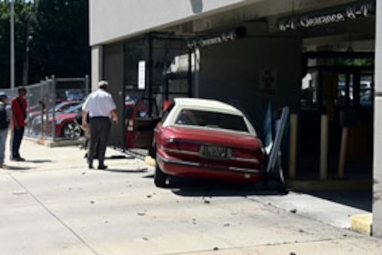 A red Buick LeSabre crashed into the cement wall of the parking garage. (ROBERT McGOVERN / Philly.com)