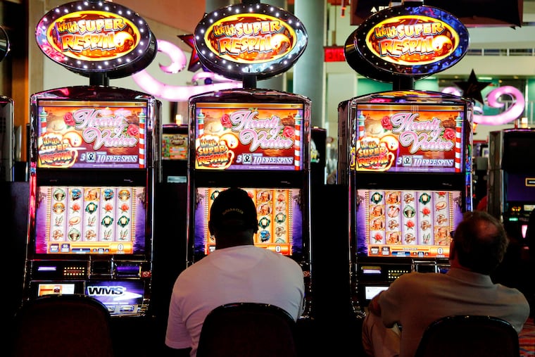 Patrons play the slot machines at Harrah's Philadelphia Casino & Racetrack in Chester, Pa. The casino's parent is being sued for copyright infringement.