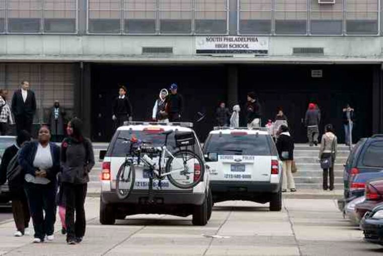 At dismissal time , students leaving South Philadelphia High walk past school police vehicles stationed prominently. On Thursday, about 30 students were attacked in and outside the school in a surge of racial violence targeting Asians.