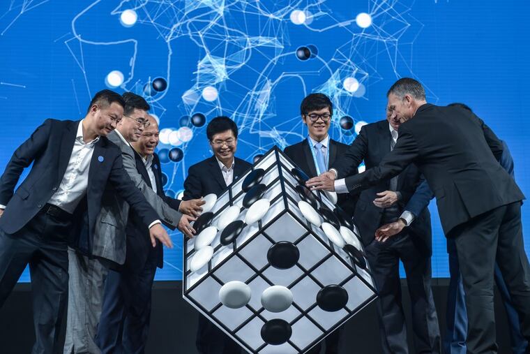 Chinese Go player Ke Jie, third from right, and other guests attend the opening ceremony of the Future of Go Summit before a match between him and Google's artificial intelligence program AlphaGo. Nowe the feds want to use AI to comback child porn.