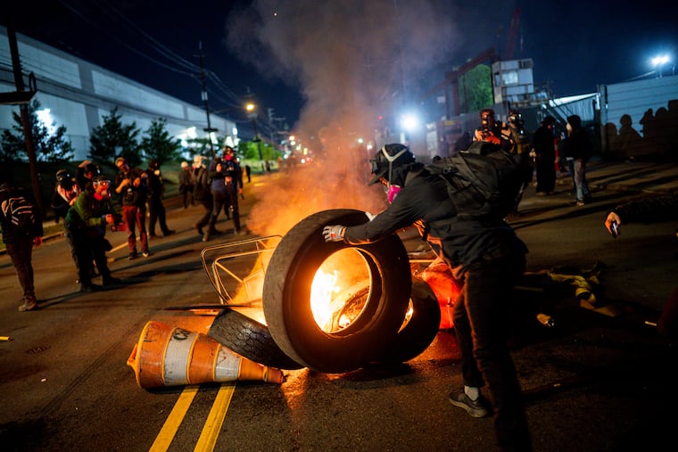 Demonstrators set debris on fire outside the Delaney Hall immigration detention center in Newark, N.J., on May 30.