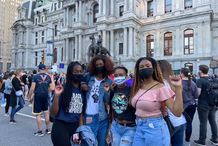 Temple students (left to right) Zayna McNeil, 21, Lauren Jackson, 18, Merissa Chase, 20, and Rachelle Small, 20, pose in front of City Hall, fists up. It is “amazing to see myself represented in such a high power,” Jackson said, referring to Harris. “Not only as Black people but as a woman and minority in the office," Small said, “this is history being made.”