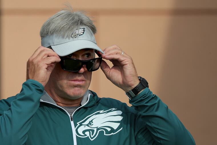 Eagles head coach Doug Pederson peers over his sunglasses during training camp last week.