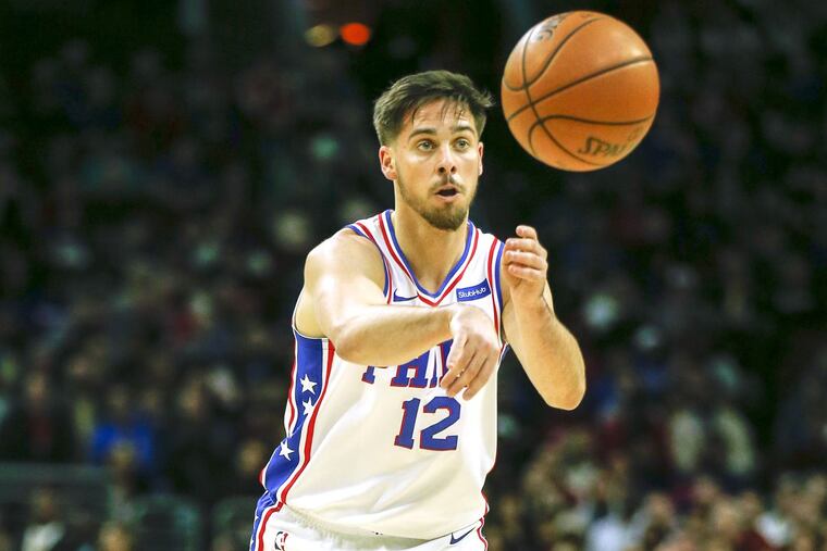 Sixers guard T.J. McConnell passes the basketball against the Orlando Magic on Saturday, November 25.
