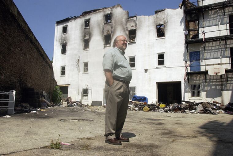 Just after the February 2006 fire that tore through the mission, the Rev. Bob Emberger reviewed the wreckage. The mission helps men with drug and alcohol problems rebuild their lives.