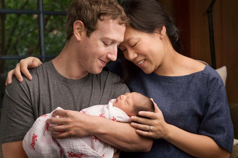 Maxima "Max" Chan Zuckerberg is held by her parents, Mark Zuckerberg and Priscilla Chan, in a photo provided by the Facebook founder.