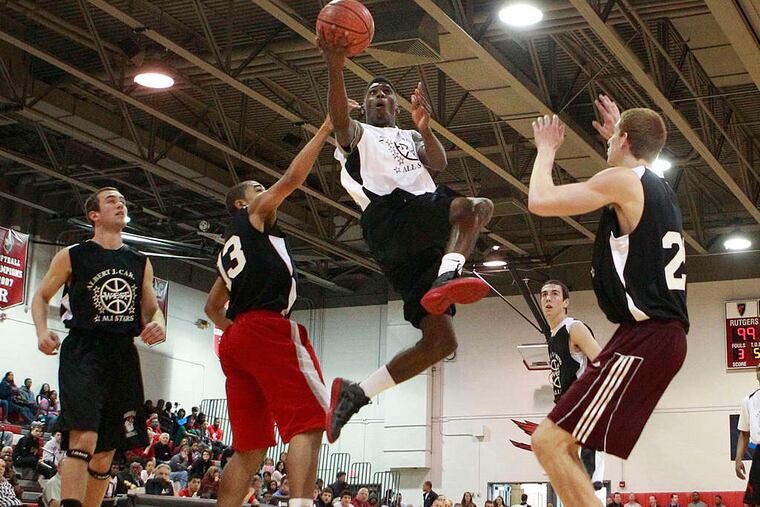 (Holy Cross) splits a pair of West defenders on his way to the basket. Smith scored 12 points in the East squad's 118-101 victory.