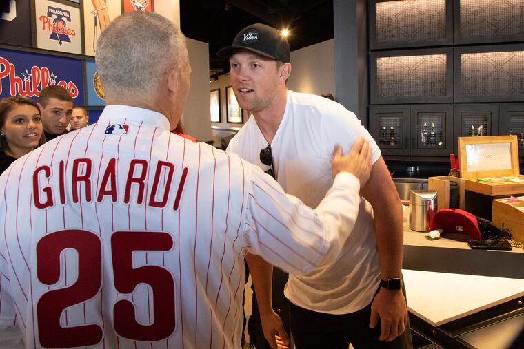 New Phillies manager Joe Girardi greets first baseman Rhys Hoskins after Monday's introductory news conference inside the Pass and Stow restaurant at Citizens Bank Park.