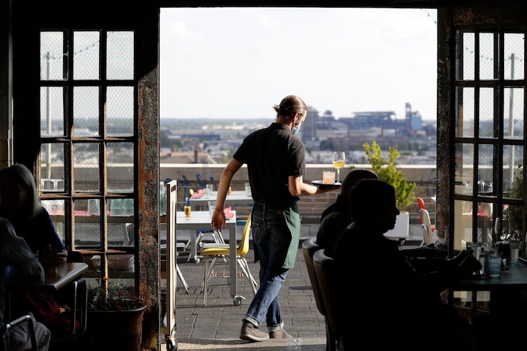 A server brings drinks to guests dining at Irwin's in the Bok building in 2021. After visiting the restaurant, named one of the best in the country, during an ill-fated trip this March, a Rhode Island state official rudely said it looked like "it was vandalized just before our arrival.”