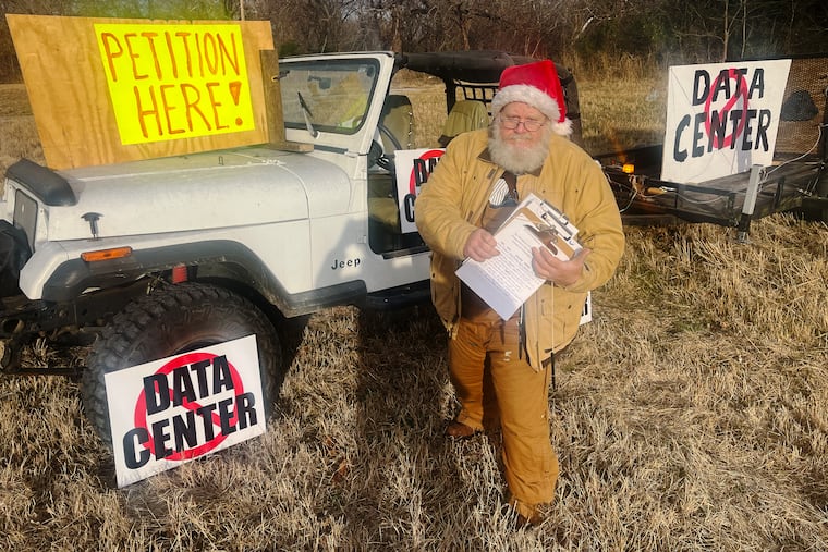 Allen Prather at the roadside petition drive he set up outside his home. The city of Coweta, Okla., is weighing a proposal to build a large data center adjacent to Prather’s property.