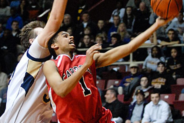 Carroll's Yosef Yacob goes up to score over LaSalle's Brennan Woods in
4th period action. (Ron Tarver / Staff Photographer)
