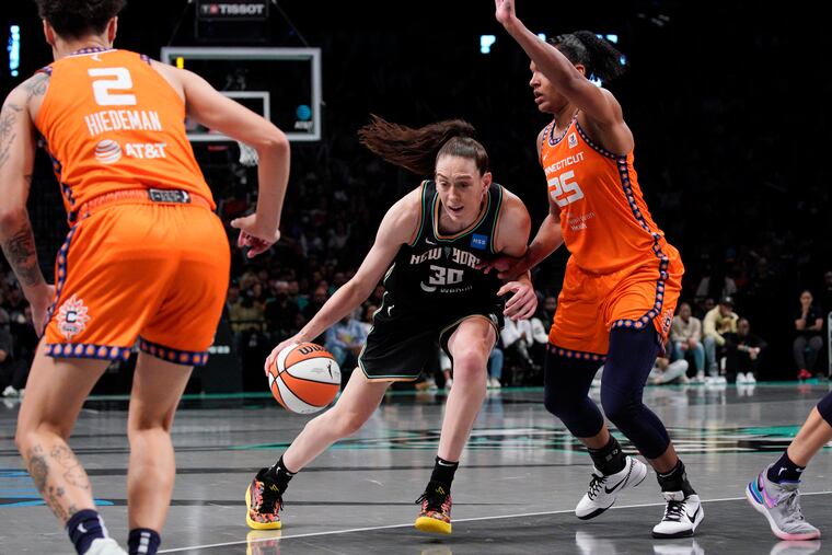 New York Liberty forward Breanna Stewart (center) drives to the basket as the Connecticut Sun's Alyssa Thomas defends during a playoff game on Monday.