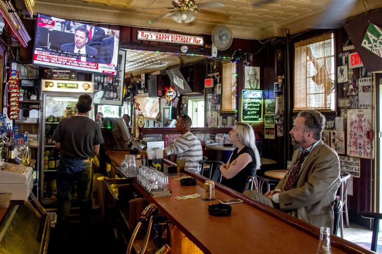 Patrons of Ray’s Happy Birthday Bar on Passyunk Ave. watch former FBI director James Comey testify.