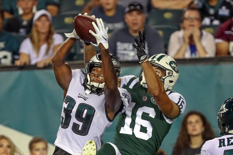 Eagle cornerback Chandon Sullivan intercepts the football against Jets wide receiver Chad Hansen during a preseason game.