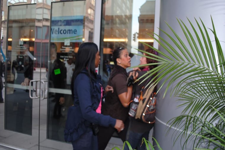 Amanda Geraci is pressed against a wall by a Philadelphia Police officer after she tried to video-record cops responding to a protest.