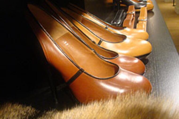 Dries Van Noten shoes are among the styles that boutique owner Joan Shepp and her daughter Ellen Shepp-Weinstein check out in Paris. (Elizabeth Wellington / Inquirer staff)