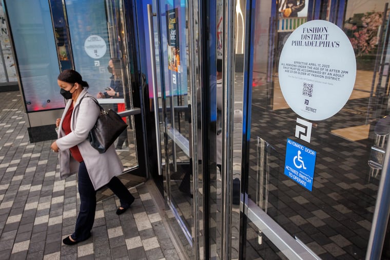 Commuters exit the Fashion District doors at 9th and Market Street.