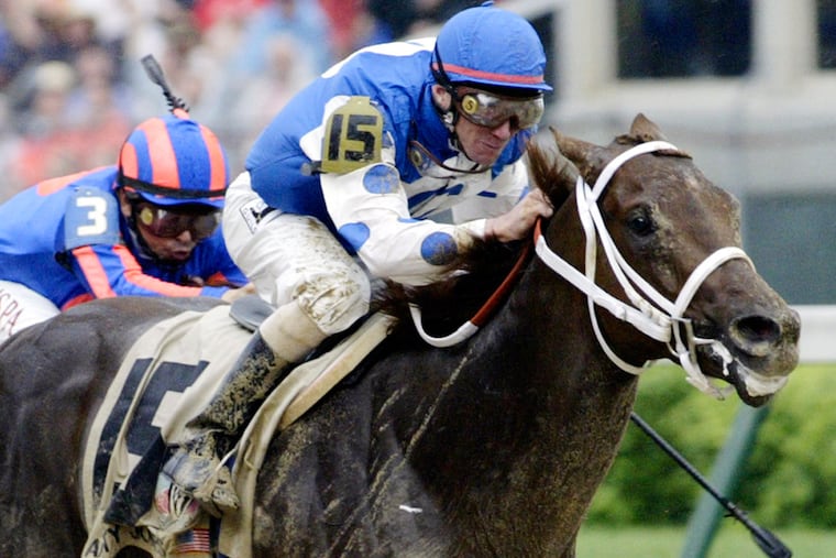 Smarty Jones, with jockey Stewart Elliott up, winning the Kentucky Derby on May 1, 2004.