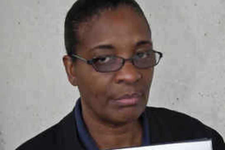 Viola Leigertwood holds picture of her with her son.