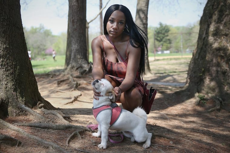 Lauren-Rebecca Davis with her dog, Lola, at Charles A. Papa Playground in West Philadelphia. Davis has felt lonely since her friends are able to still go out late while she is pregnant with twins.