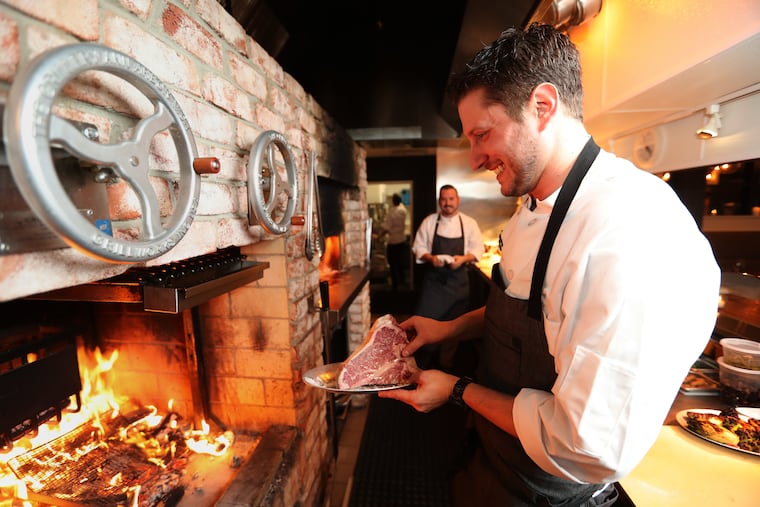 Aaron Gottesman prepares grill a 35 oz. porterhouse steak at Hearthside, 801 Haddon Ave., Collingswood, N.J. November 21, 2017. Hearthside was listed on a platform selling reservations for the restaurant that is now illegal in New Jersey.