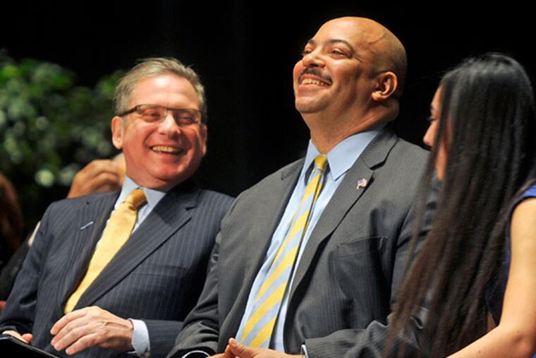 District Attorney Seth Williams (right) and Controller Alan Butkovitz (left) share a laugh onstage at the Academy of Music before being sworn in to new terms in office January 6, 2014. ( TOM GRALISH / Staff Photographer )
