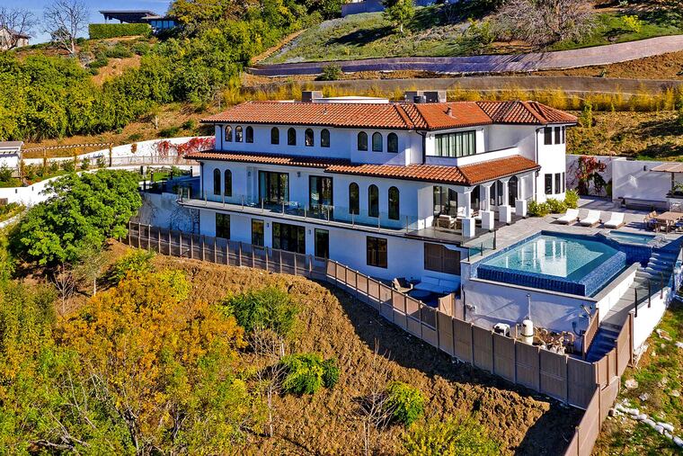 Retired basketball star Dwyane Wade and his actress wife, Gabrielle Union, listed the Sherman Oaks residence for $6.2 million in early 2020. The three-story villa sits on three-quarters of an acre with city and valley views. An infinity-edge swimming pool, lounge, fenced play yard and outdoor kitchen make up the grounds. (PostRAIN Productions/Handout/Los Angeles Times/TNS)