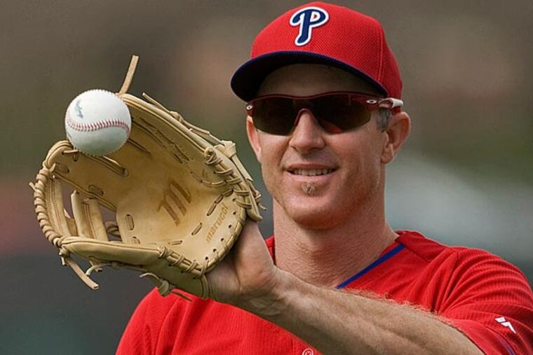 Philadelphia Phillies infielder Chase Utley, right, plays catch during the team's first full-squad workout Tuesday, Feb 24, 2015n at the Phillies spring training baseball facility in Clearwater, Fla. (Steve Nesius/AP)