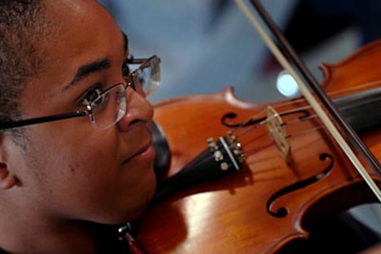 Eighth grader Alem Ballard in a class for orchestra majors. In sixth grade, each student picks an area of the arts on which to focus. (TOM GRALISH / Staff Photographer)
