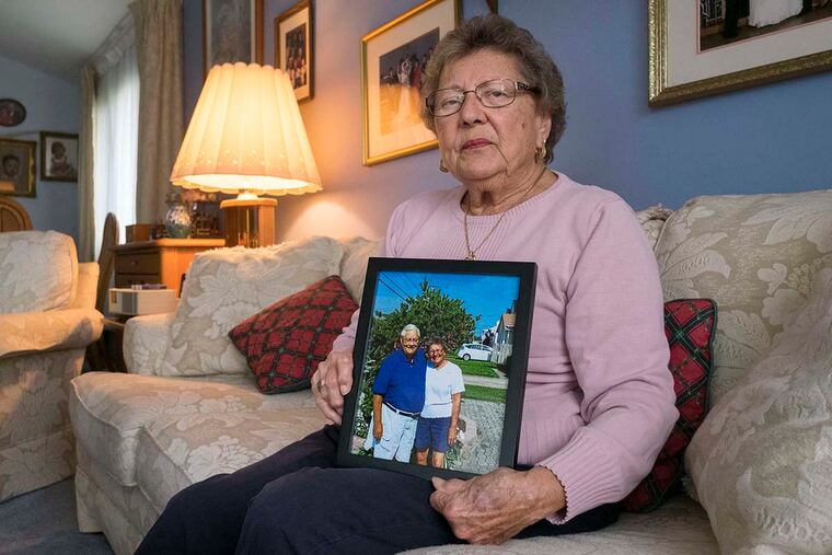 Friday September 30, 2016 Marie Wrigley sits in her Abington home holding a photo of she and her husband John in happier days at their summer home in Brigantine. John died last February and his wife is angry at three area nursing homes she says mistreated him., ED HILLE / Staff Photographer