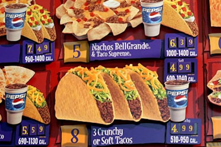 A sign at Taco Bell in 30th Street Station now lists calories of menu items. The first phase of Philadelphia’s new law covers chains with at least 15 other locations nationwide. (APRIL SAUL / Staff Photographer)